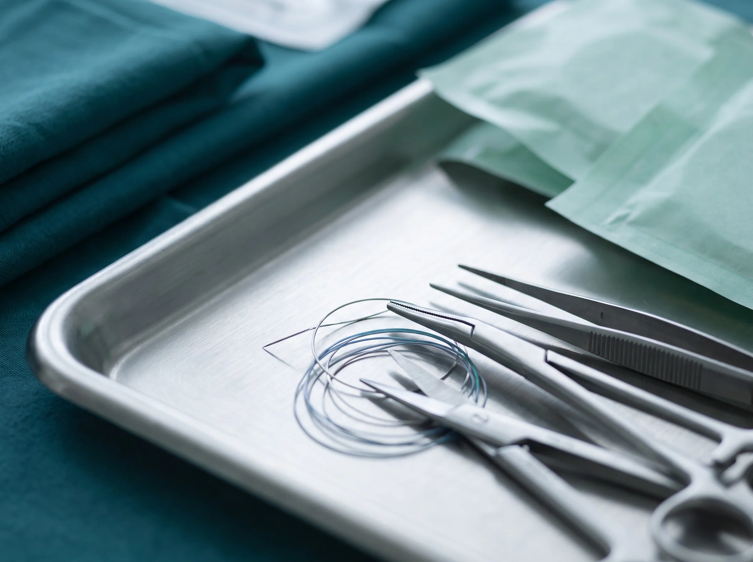 Surgical instruments and sutures on a steel tray